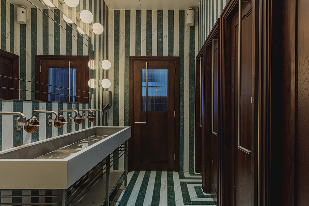 Washrooms with pistachio striped wallpaper